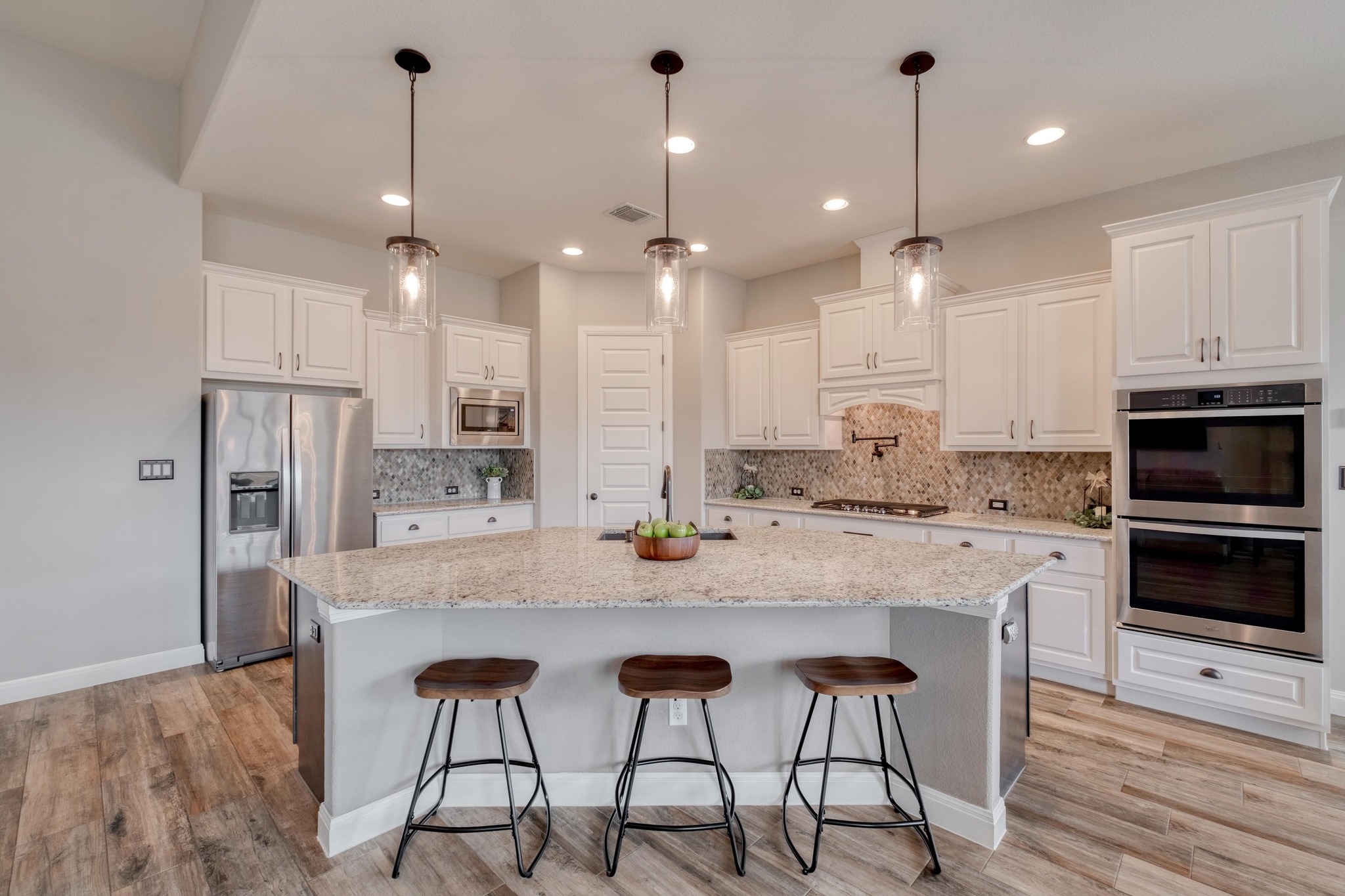 3836 Kyler Glen Road Round Rock, TX 78681 - Photo 5 of 38 a kitchen with stainless steel appliances kitchen island granite countertop a stove a sink and a refrigerator