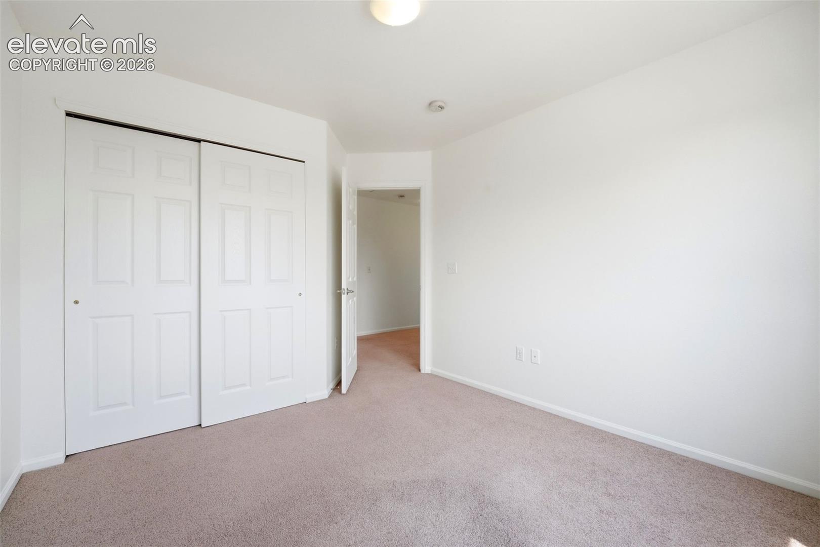 7904 Coffee Road Peyton, CO 80831 - Photo 27 of 48 Neutral-toned carpeting complements the light-colored walls in this space