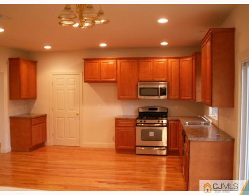 19 Parkerson Road Edison, NJ 08817 - Photo 2 of 7 a kitchen with stainless steel appliances granite countertop a stove a sink and a microwave
