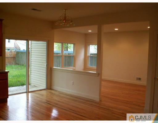 19 Parkerson Road Edison, NJ 08817 - Photo 3 of 7 wooden floor in an empty room with a window