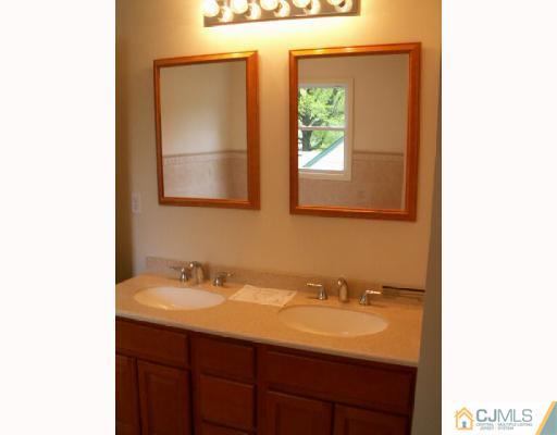 19 Parkerson Road Edison, NJ 08817 - Photo 6 of 7 a bathroom with a sink and a mirror