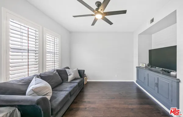 a living room with lots of furniture and wooden floor