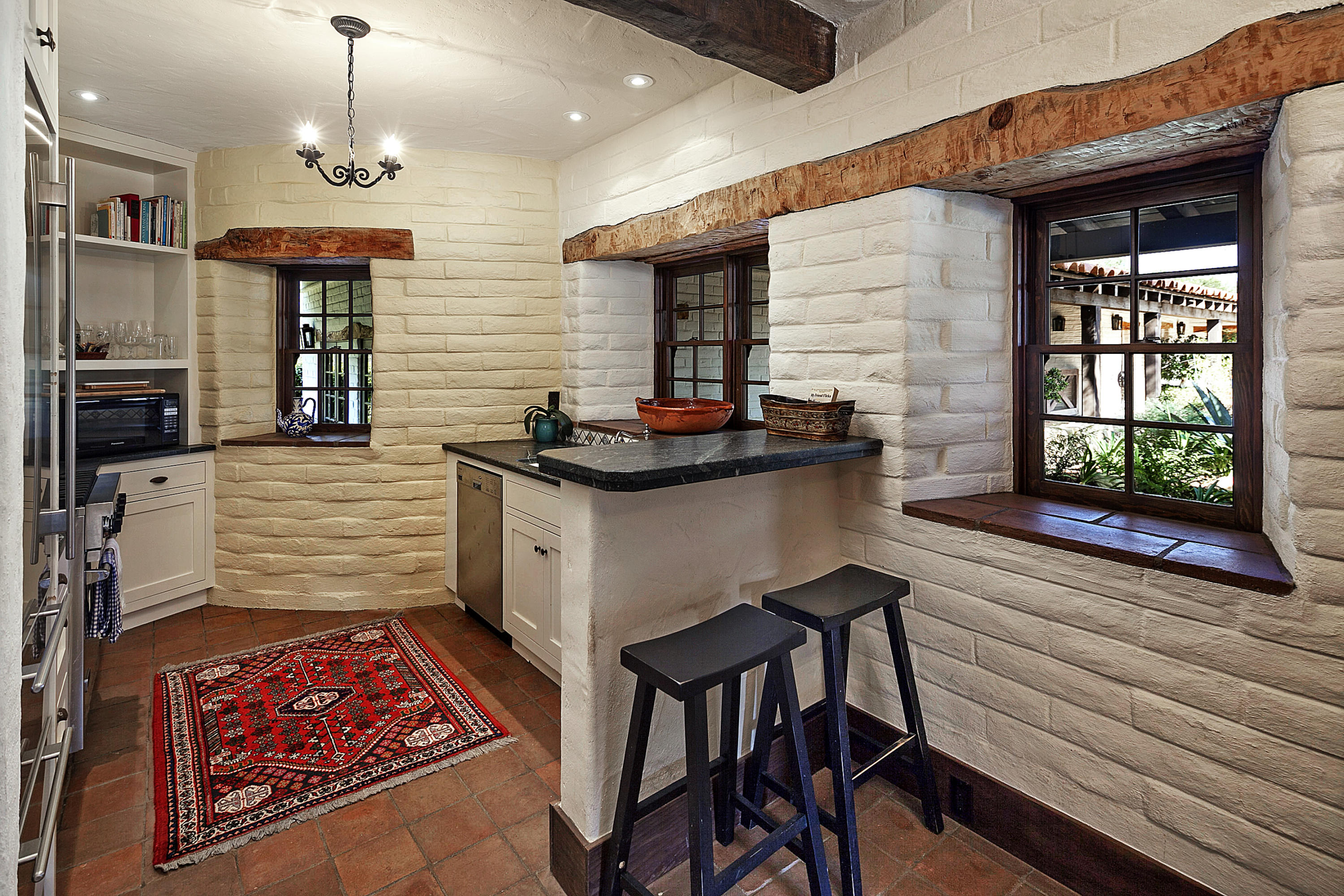 308 Ennisbrook Drive Montecito, CA 93108 - Photo 6 of 31 a hallway with a stove a faucet a chandelier and a fireplace
