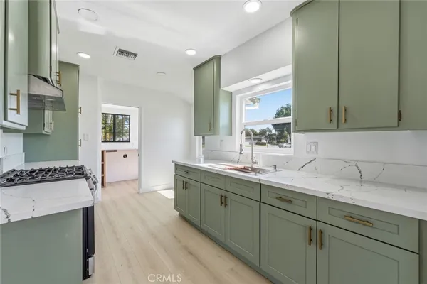 a spacious bathroom with a sink and mirror