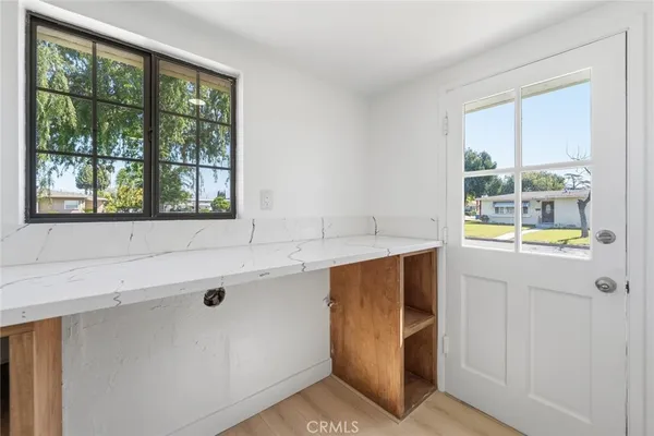 a view of kitchen with windows and refrigerator