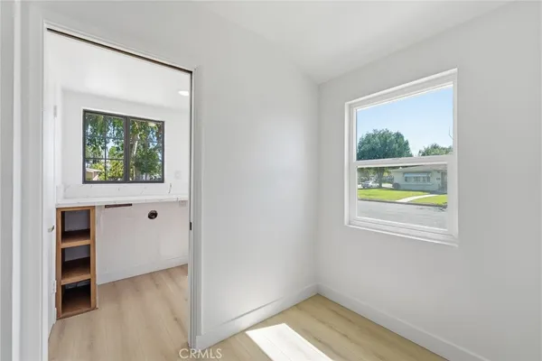 an empty room with windows and closet