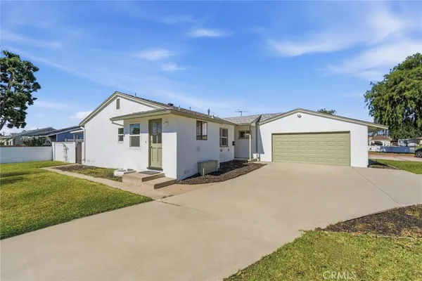 a view of a house with a yard and garage