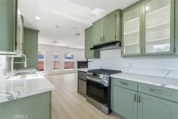 a kitchen with stainless steel appliances granite countertop a stove and a sink