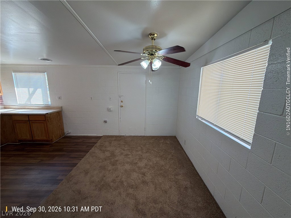 Plentiful natural light fills this versatile living space featuring low-maintenance carpet and durable flooring.