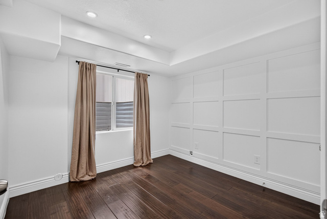 2223 North Pointe Meadow Loop Lehi, UT 84048 - Photo 33 of 56 Room featuring dark wood-finish flooring, recessed lighting, and a white accent wall with panel molding