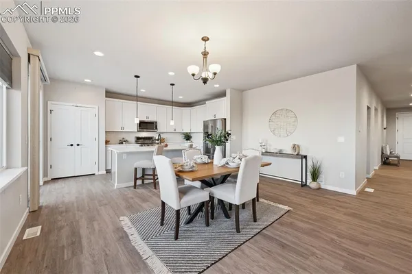 a view of a dining room with furniture and wooden floor