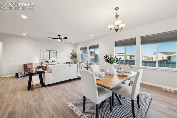 a view of a dining room with furniture and wooden floor