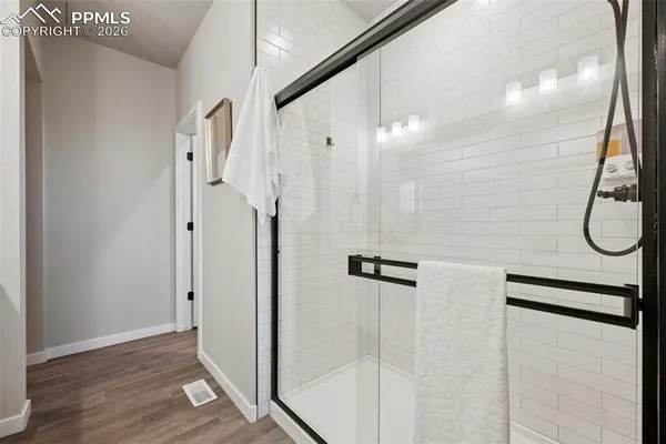 a bathroom with a glass shower door
