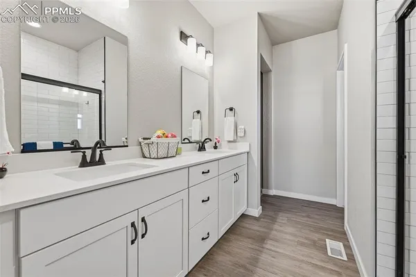 a bathroom with a double vanity sink mirror and double