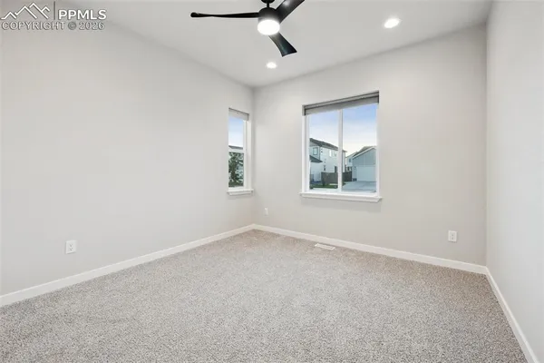 an empty room with a empty space and windows