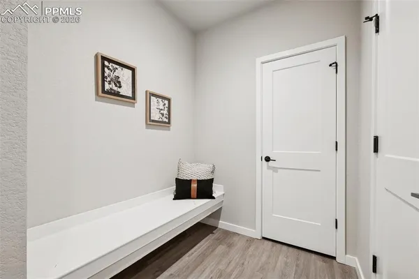 a view of hallway with view and wooden floor