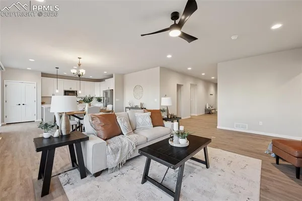 a living room with furniture and kitchen view