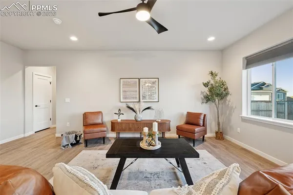 a living room with furniture a table and a large window