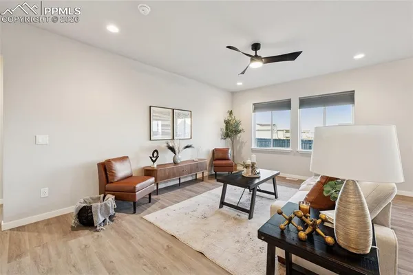 a living room with furniture and a wooden floor