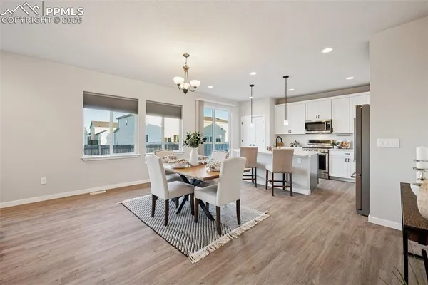 a view of a dining room with furniture and wooden floor