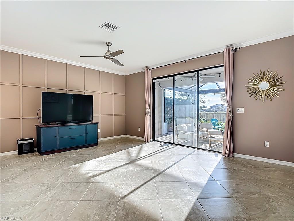 19890 Beverly Park Road Estero, FL 33928 - Photo 17 of 38 Unfurnished living room featuring a ceiling fan and ornamental molding