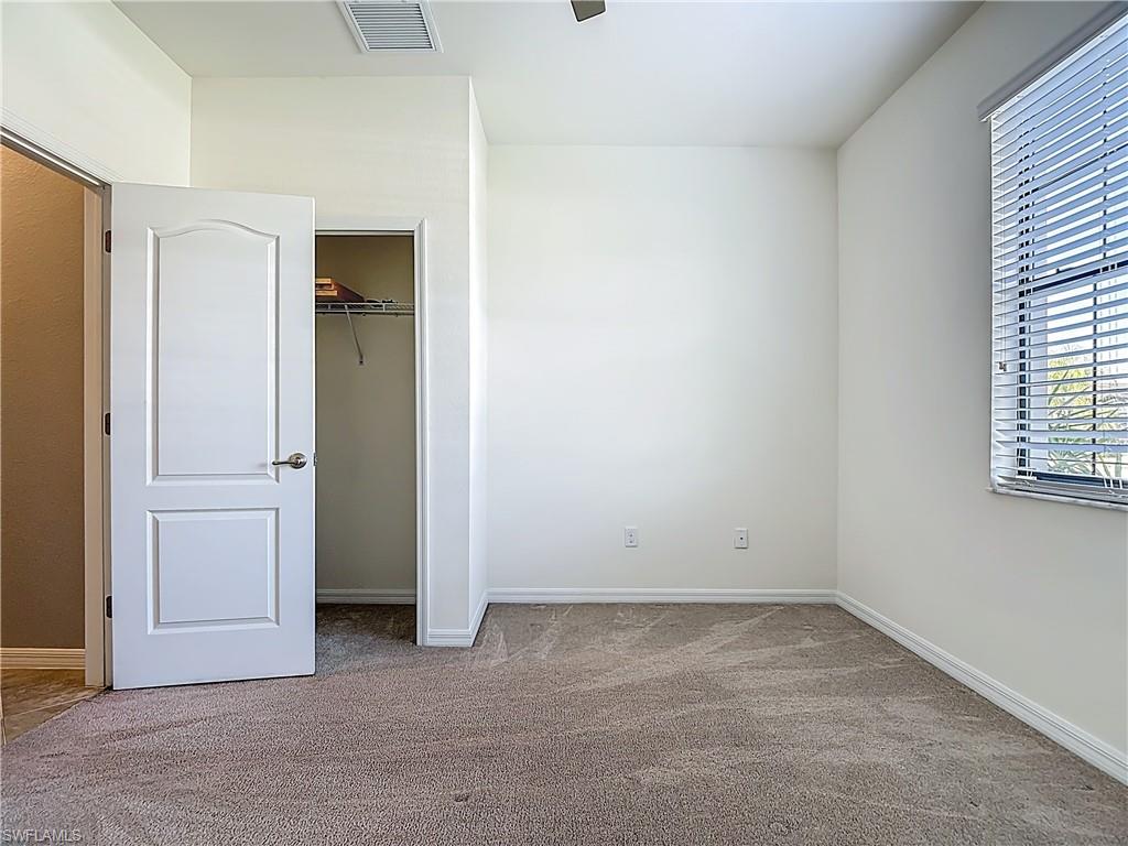 19890 Beverly Park Road Estero, FL 33928 - Photo 22 of 38 Unfurnished bedroom with light colored carpet and a closet