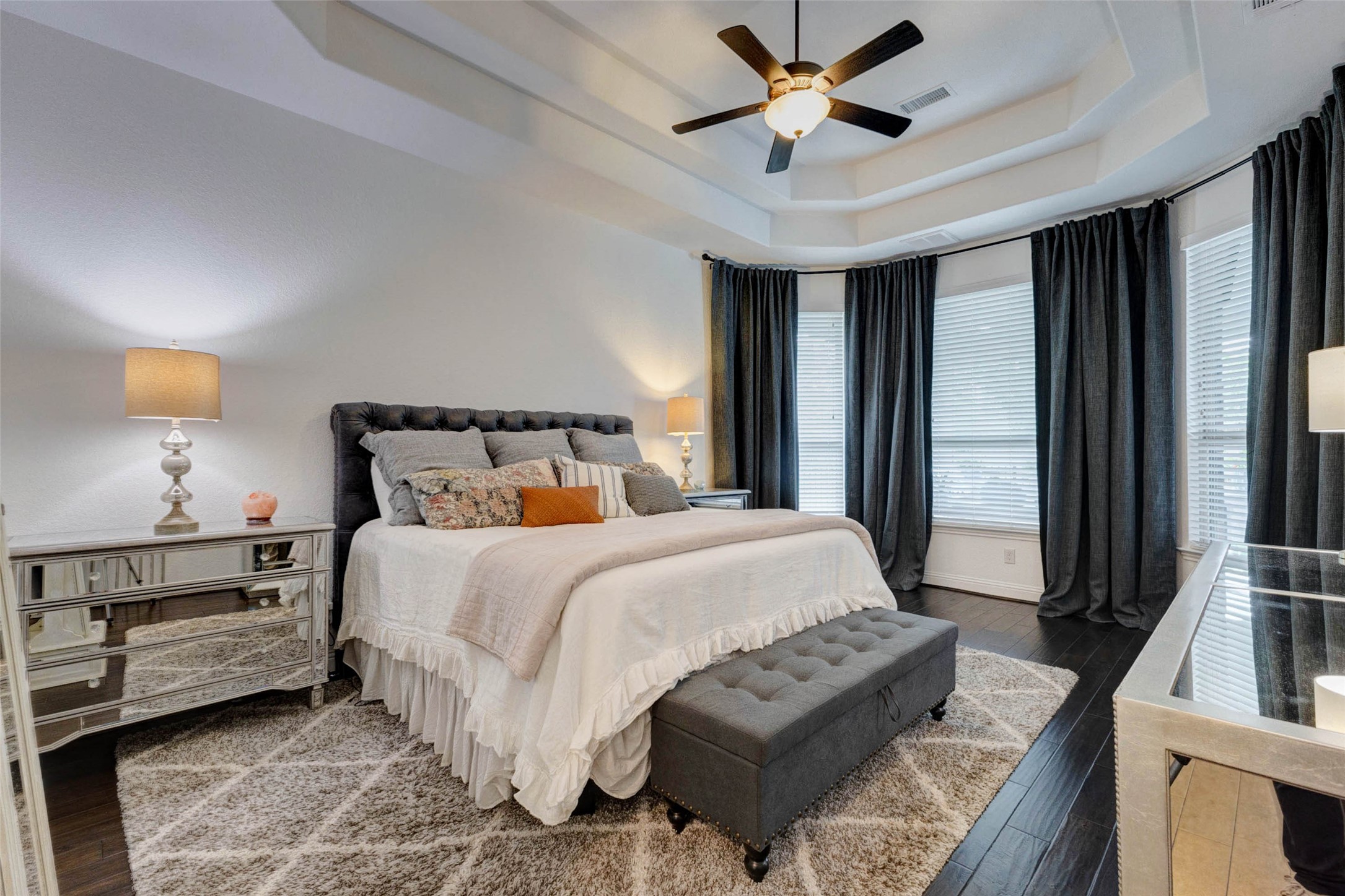 29903 Spring Side Court Fulshear, TX 77406 - Photo 23 of 50 a bedroom with a bed a ceiling fan and a large window