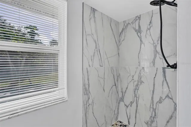 a bathroom with a shower curtain and a window