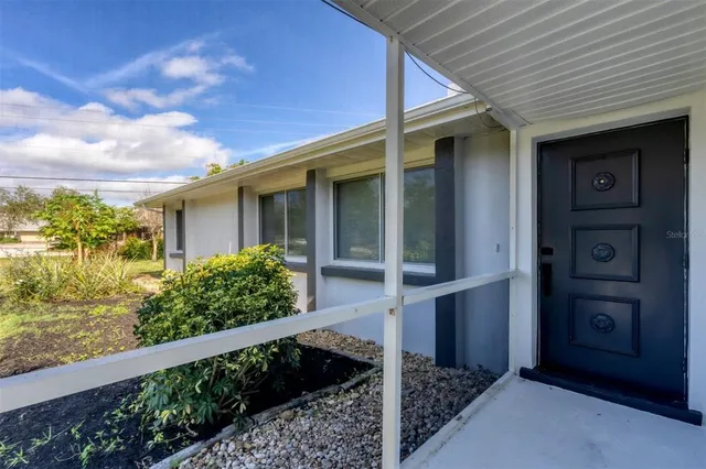 a view of a house with a flower garden