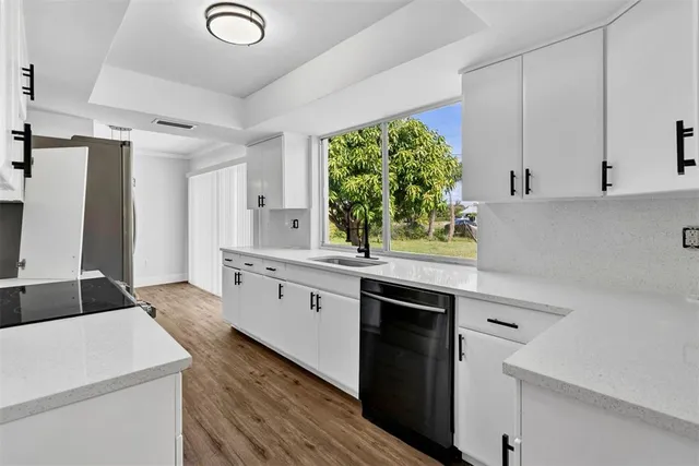 a kitchen with a sink stove and cabinets