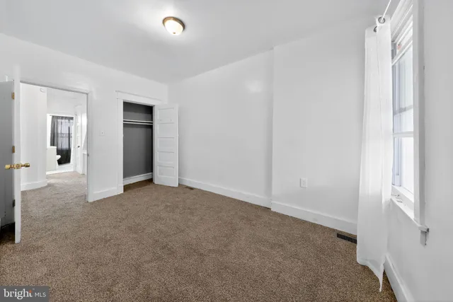 a view of an empty room with windows