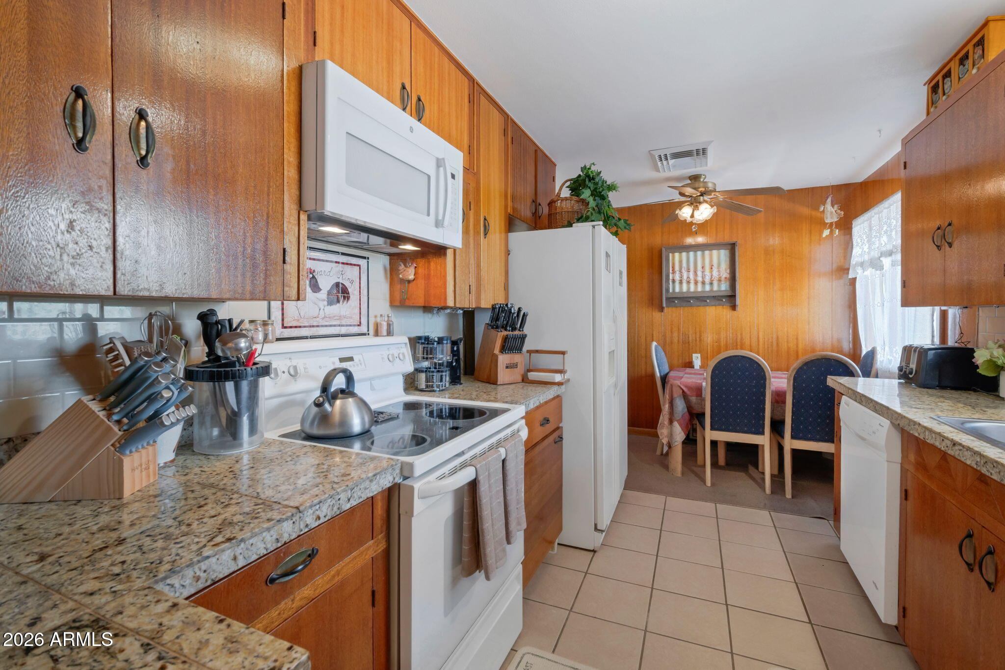 8865 North Page Road Florence, AZ 85132 - Photo 5 of 15 a kitchen with stainless steel appliances granite countertop a sink a stove and a refrigerator