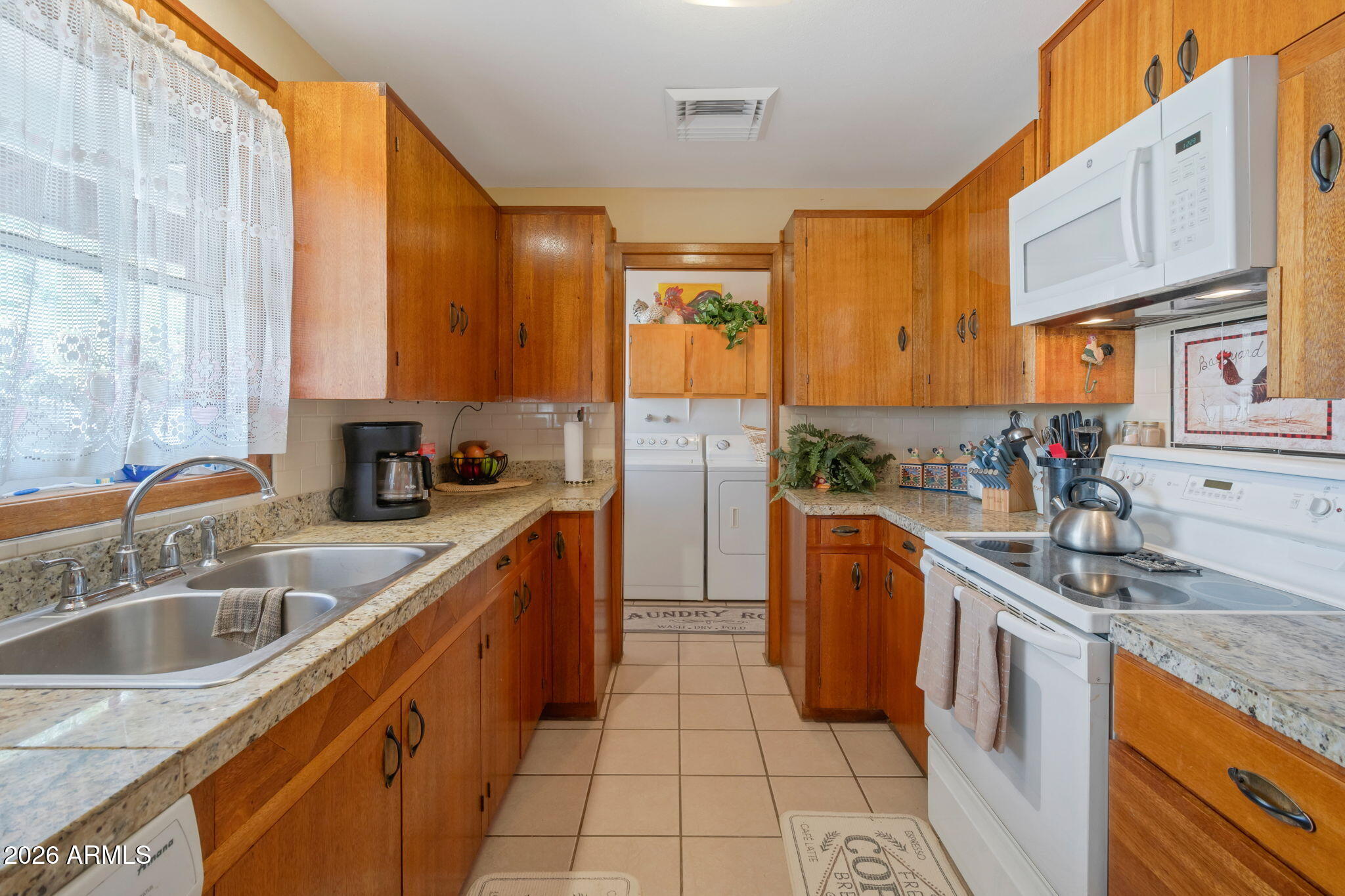 8865 North Page Road Florence, AZ 85132 - Photo 6 of 15 a kitchen with stainless steel appliances granite countertop a sink and cabinets