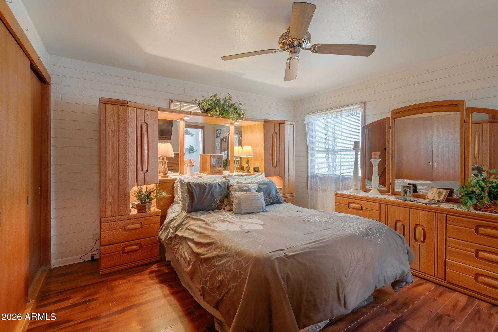 8865 North Page Road Florence, AZ 85132 - Photo 7 of 15 a bedroom with a large bed and a chandelier