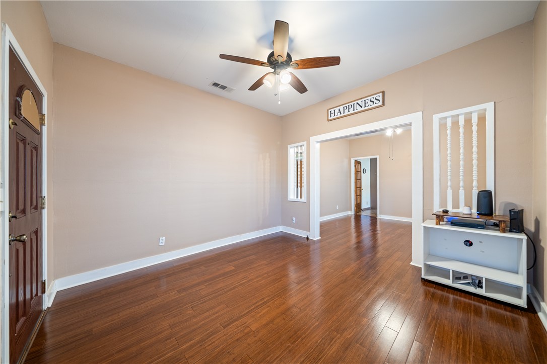 1205 10th Street Corpus Christi, TX 78404 - Photo 11 of 38 wooden floor in an empty room with a window