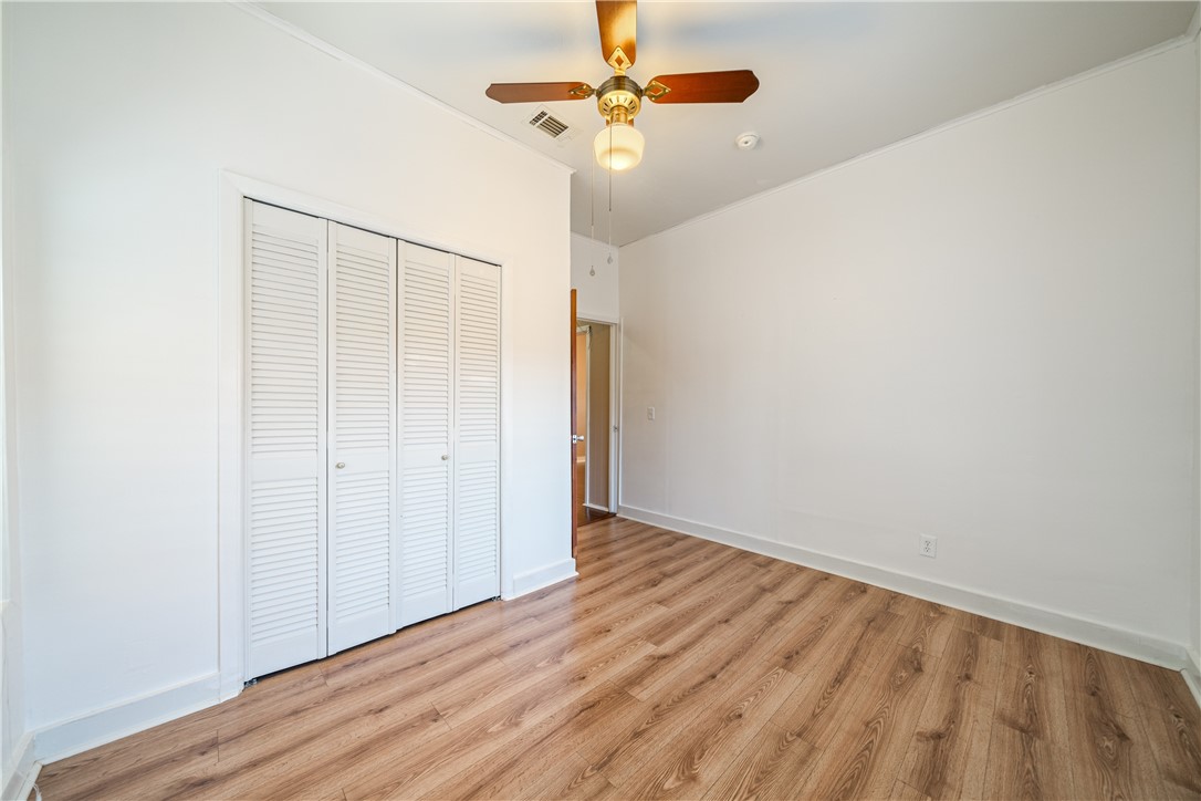 1205 10th Street Corpus Christi, TX 78404 - Photo 18 of 38 a view of an empty room with wooden floor