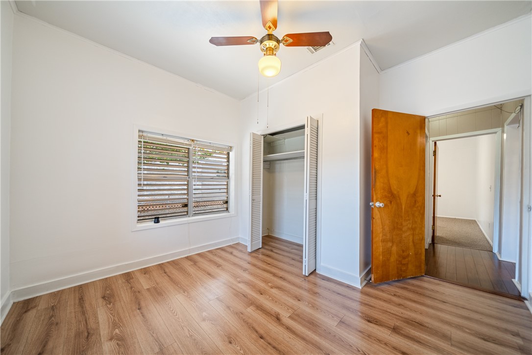 1205 10th Street Corpus Christi, TX 78404 - Photo 19 of 38 a view of an empty room with wooden floor and a window