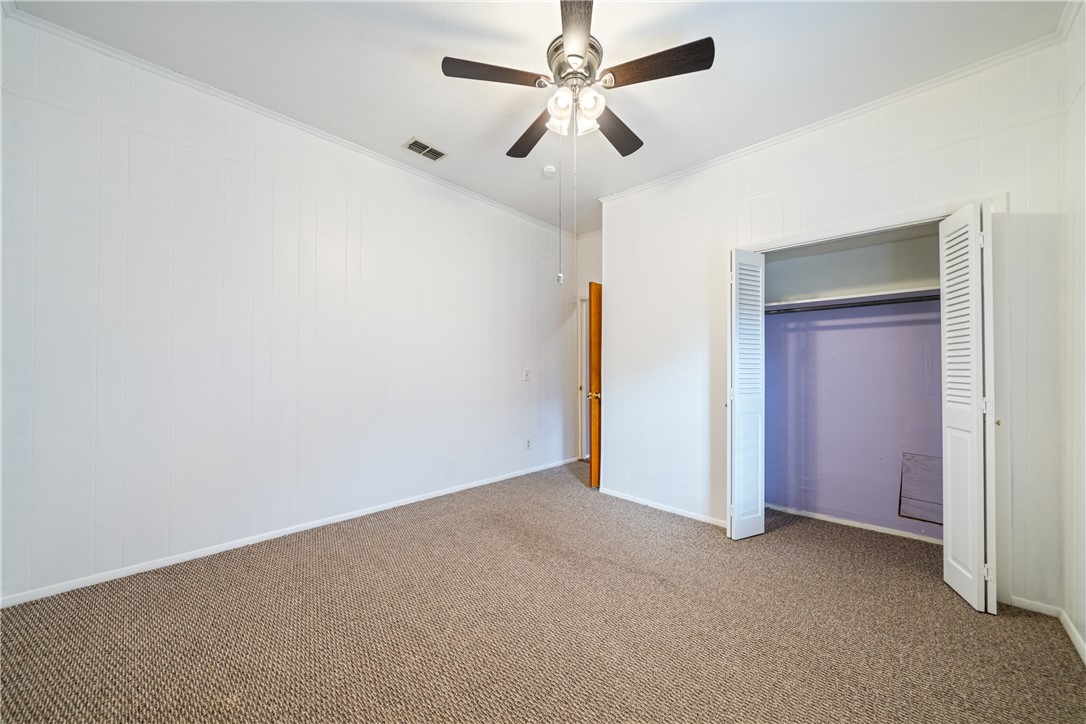 1205 10th Street Corpus Christi, TX 78404 - Photo 22 of 38 an empty room with closet and fan