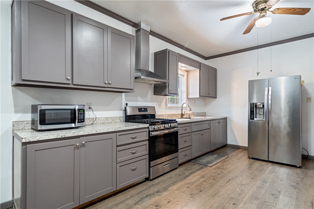 1205 10th Street Corpus Christi, TX 78404 - Photo 25 of 38 a kitchen with stainless steel appliances granite countertop a stove a sink and a refrigerator