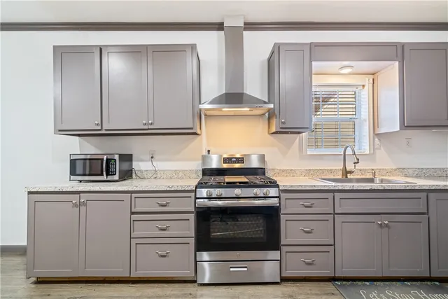 a kitchen with granite countertop a stove and a sink
