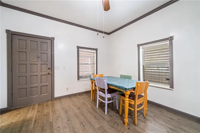 a view of a dining room with furniture and wooden floor