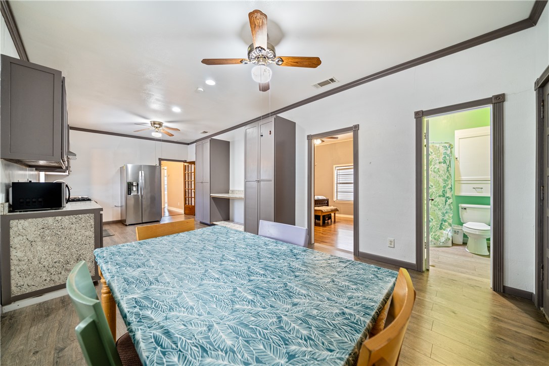 1205 10th Street Corpus Christi, TX 78404 - Photo 31 of 38 a bedroom with a bed and wooden floor