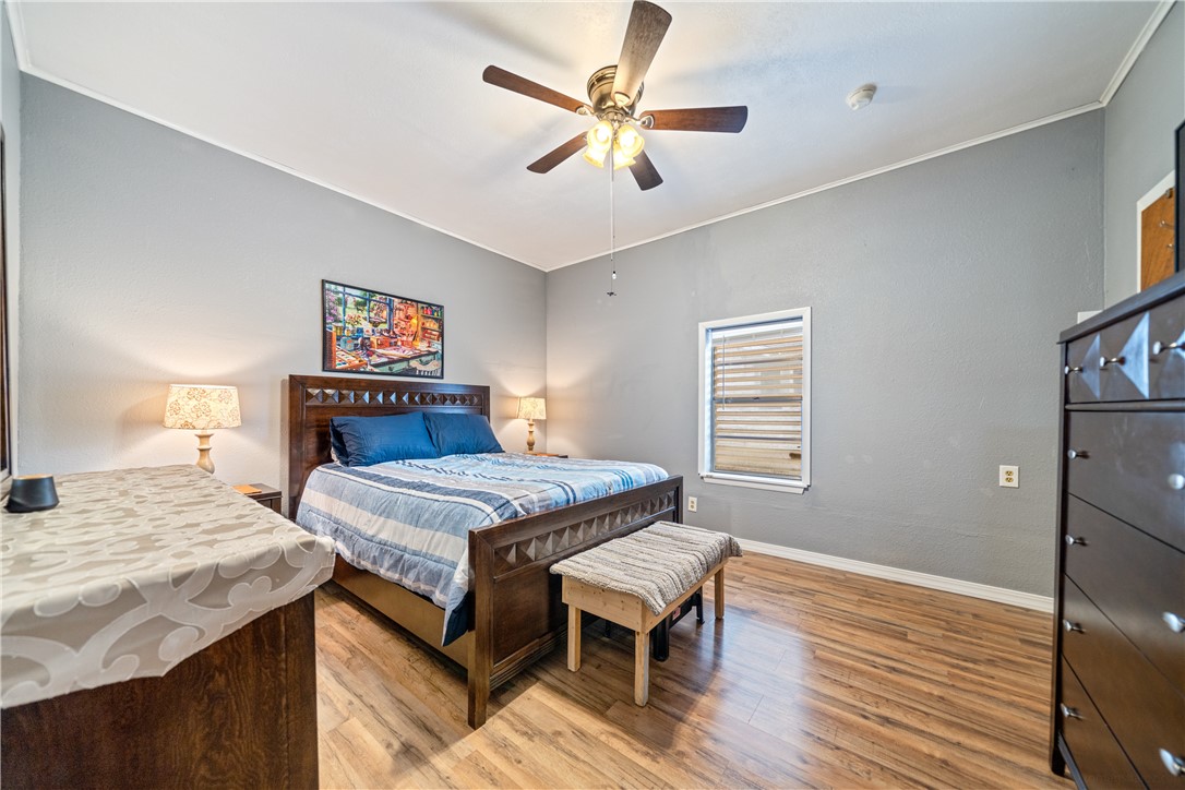 1205 10th Street Corpus Christi, TX 78404 - Photo 32 of 38 a bedroom with a bed and a table in it