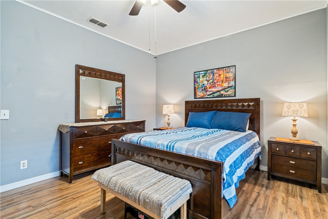 1205 10th Street Corpus Christi, TX 78404 - Photo 34 of 38 a bedroom with a bed and a dresser