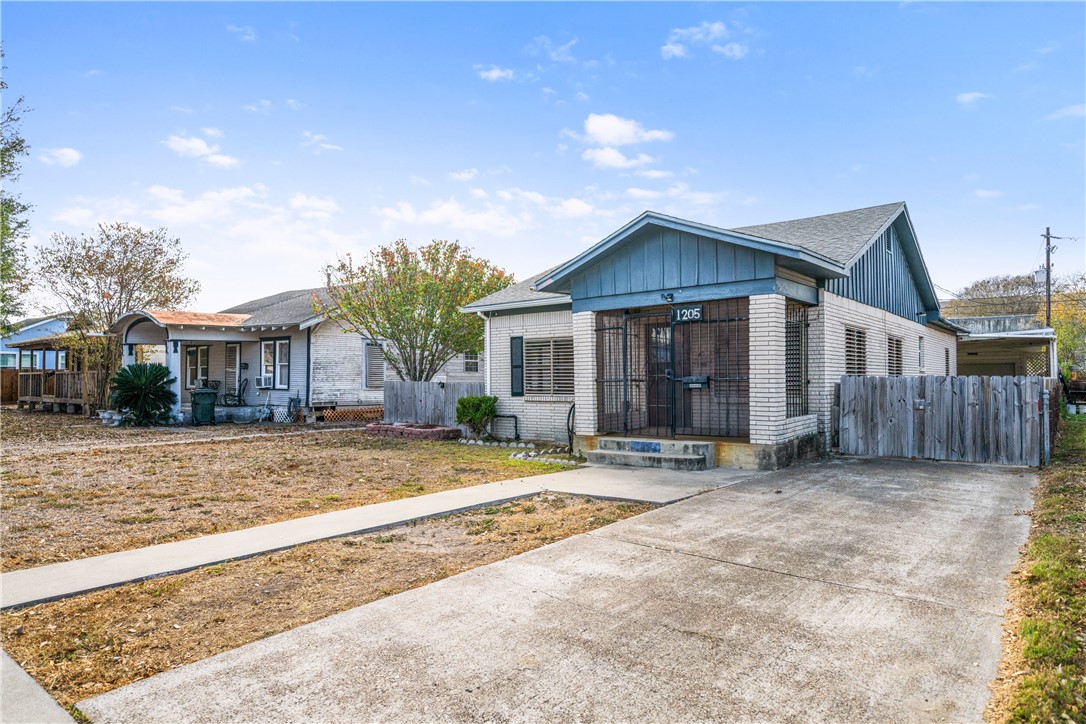1205 10th Street Corpus Christi, TX 78404 - Photo 4 of 38 a front view of a house with a garden and yard