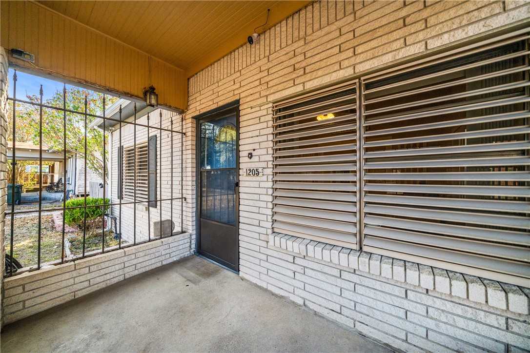 1205 10th Street Corpus Christi, TX 78404 - Photo 8 of 38 a view of a porch with a roof