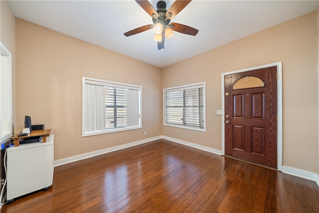 1205 10th Street Corpus Christi, TX 78404 - Photo 10 of 38 a view of an empty room with window and wooden floor