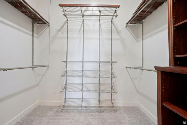 1389 Millbrook Way Bountiful, UT 84010 - Photo 38 of 74 Customizable closet system featuring wood-finish shelving, metal hanging rods, wire shelving, built-in wooden cabinetry, and neutral carpeting