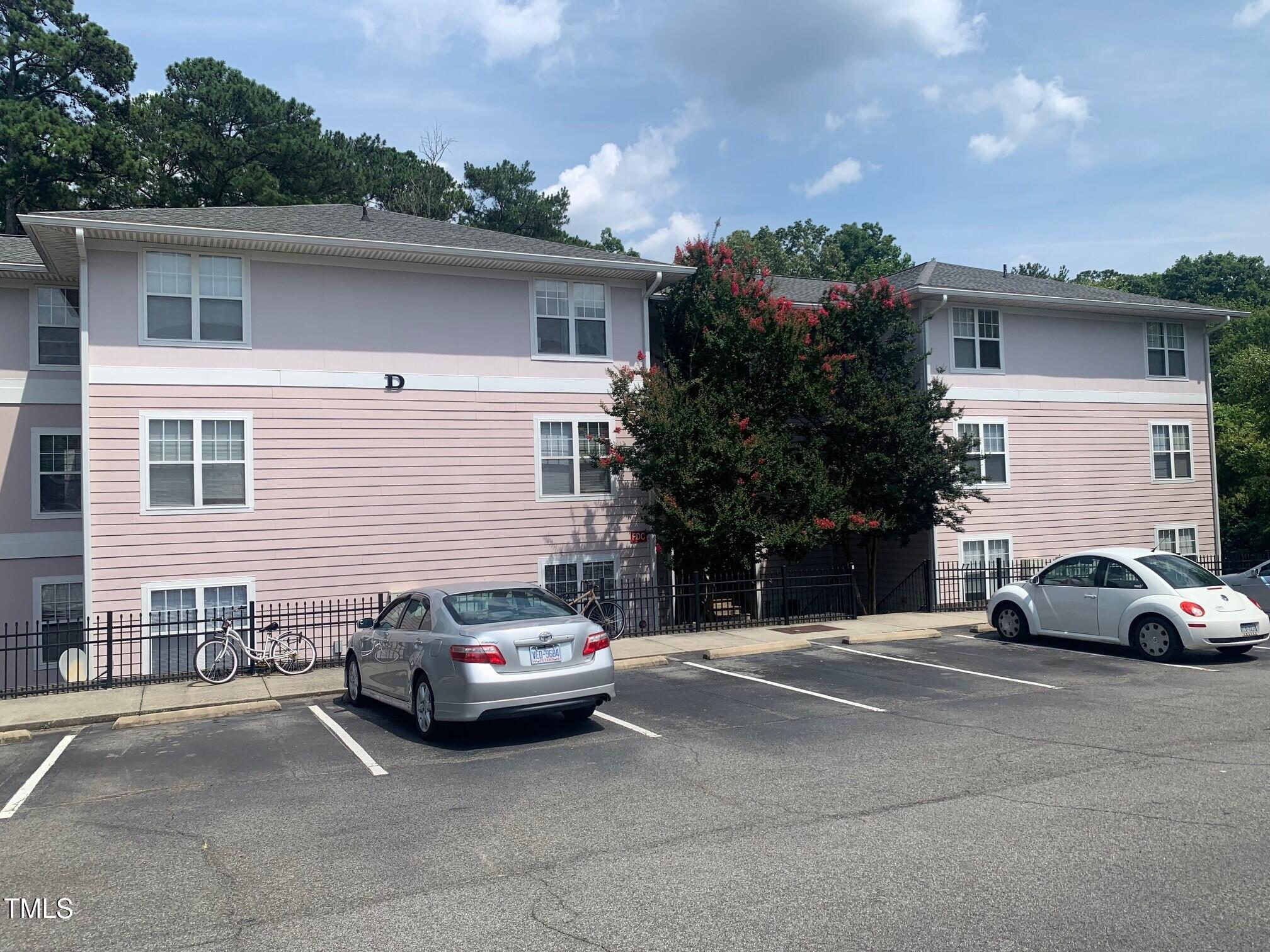 929 Morreene Road, Unit D34 Durham, NC 27705 - Photo 1 of 5 a car parked in front of a white house