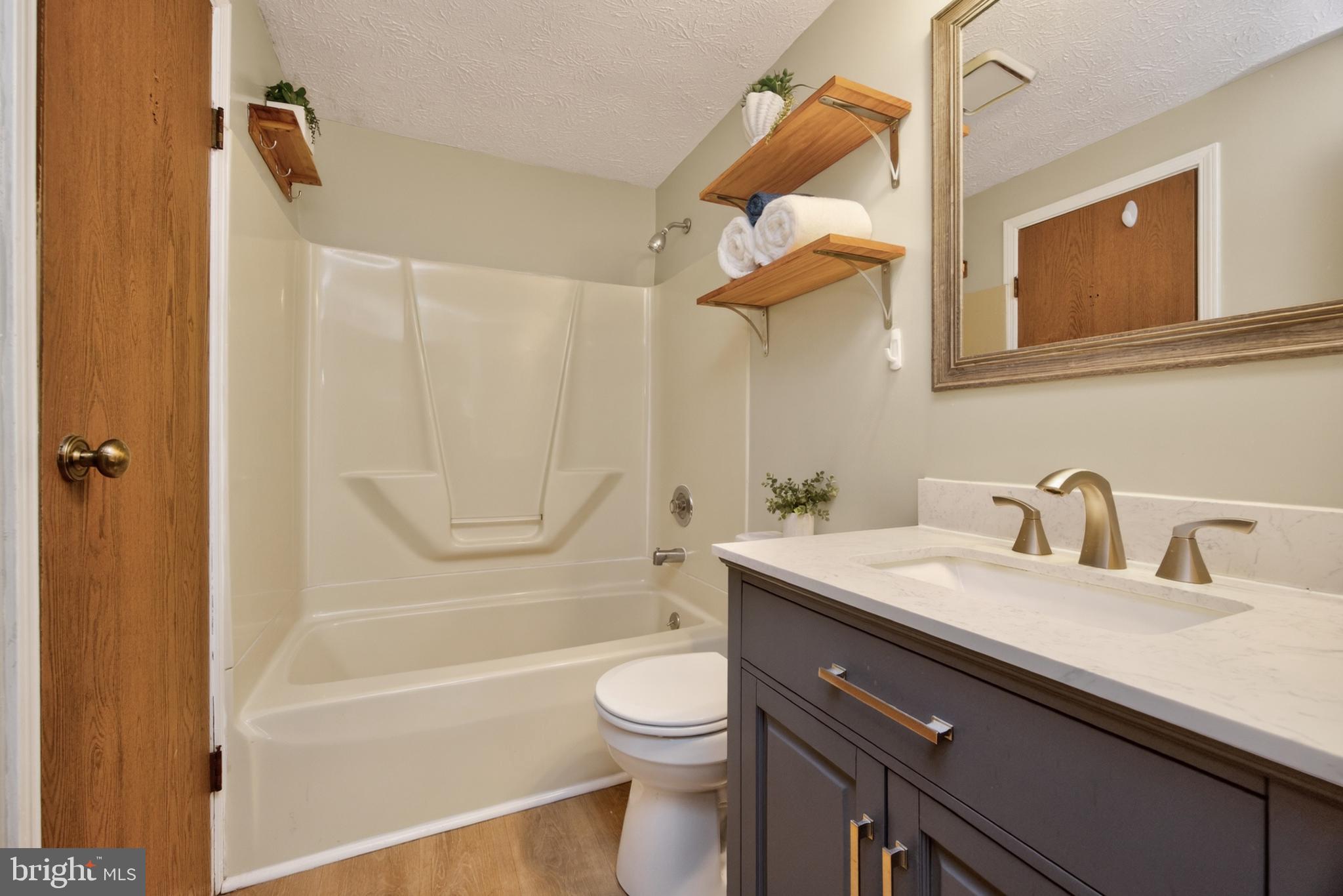 348 Barclay Street Coatesville, PA 19320 - Photo 17 of 28 a bathroom with a granite countertop sink toilet a mirror and shower